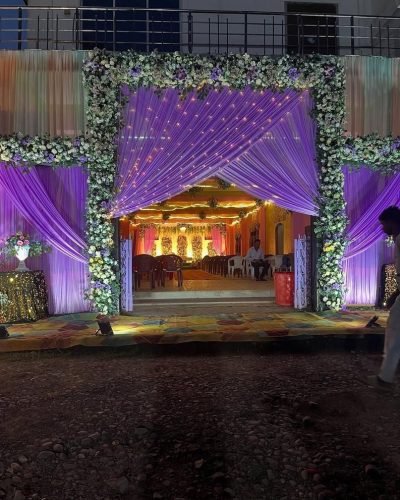 Wedding Gate With Pink Floral Backdrop And Lights – Phule Weddings