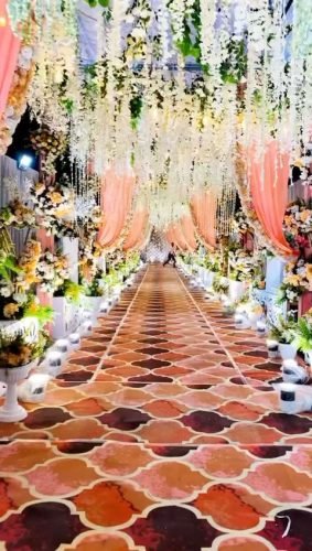 Passage Decoration With Pink Flowers And Ceiling Drapes – Phule Weddings
