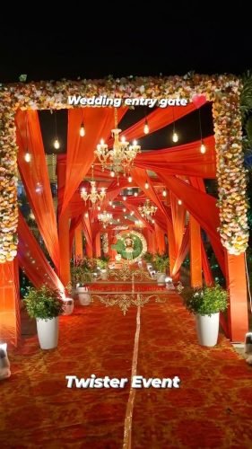 Passageway With Hanging Lamps And Fresh Flowers – Phule Weddings