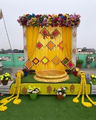 Haldi Stage Decoration With Flowers And Yellow Theme | Phule Weddings