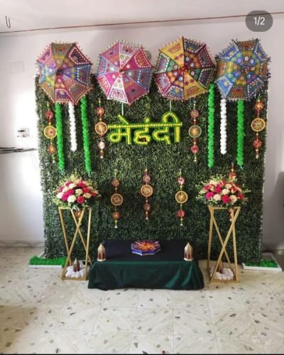 Mehndi Ceremony Hall Decoration With Floral Centerpieces And Drapes | Phule Weddings