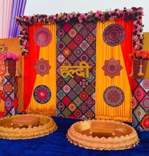 Mehndi Stage Decoration With Traditional Cushions And Green Drapes | Phule Weddings