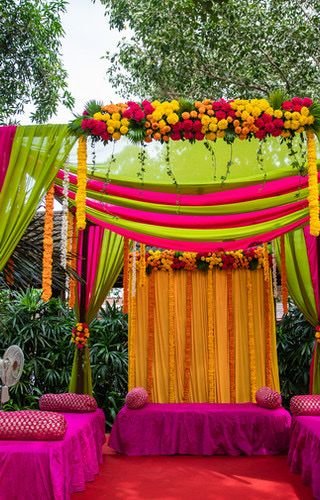 Mehndi Decoration With Floral Backdrop And Colorful Drapes | Phule Weddings